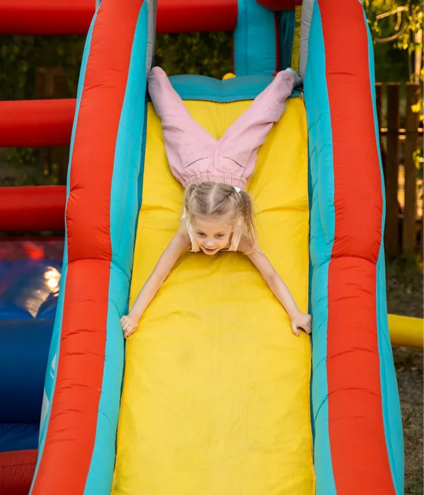 Child enjoying an inflatable slide